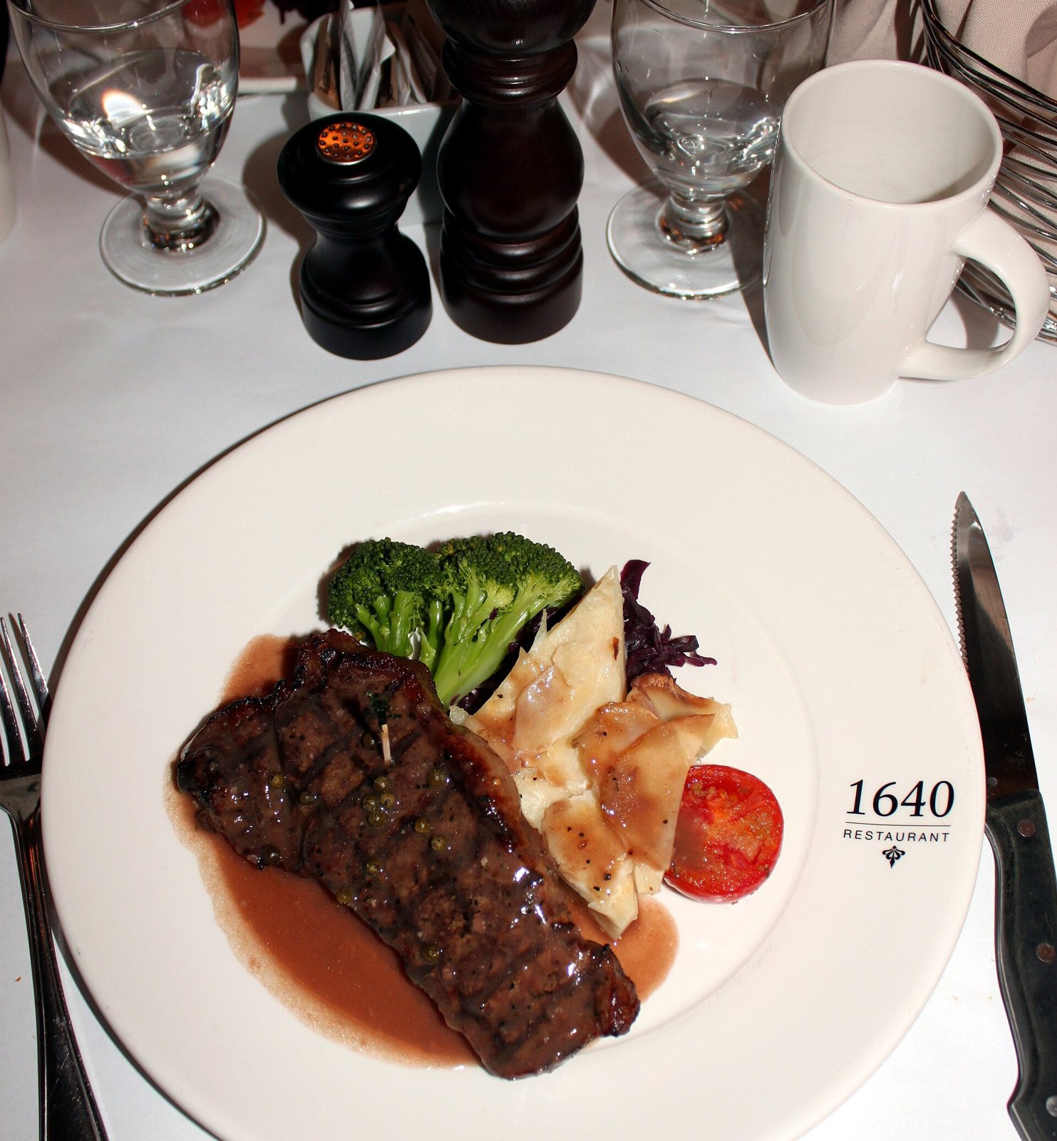 A plated steak dinner on a restaurant table