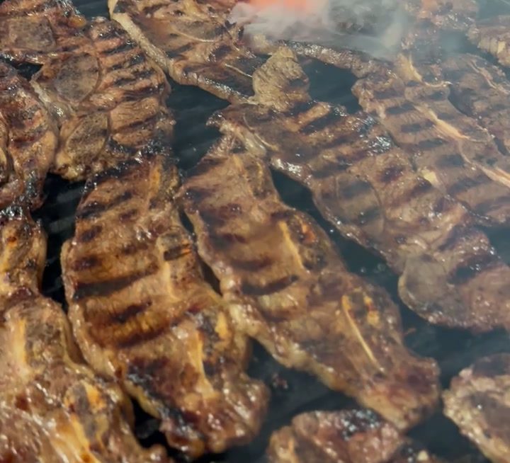 Marinated meat cooking on the grill at Guahan Grill